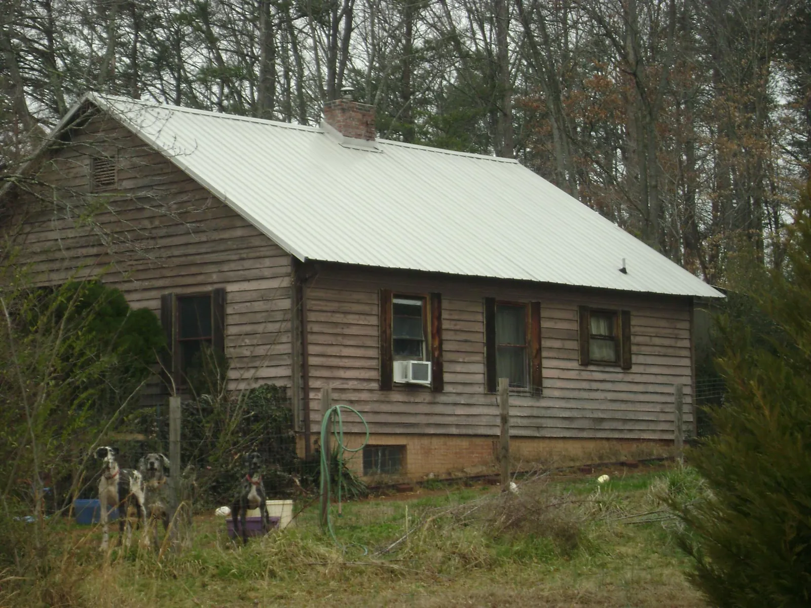 White metal roof on an old wood sided farmhouse, from a Metal Roof Installation job in Branford
