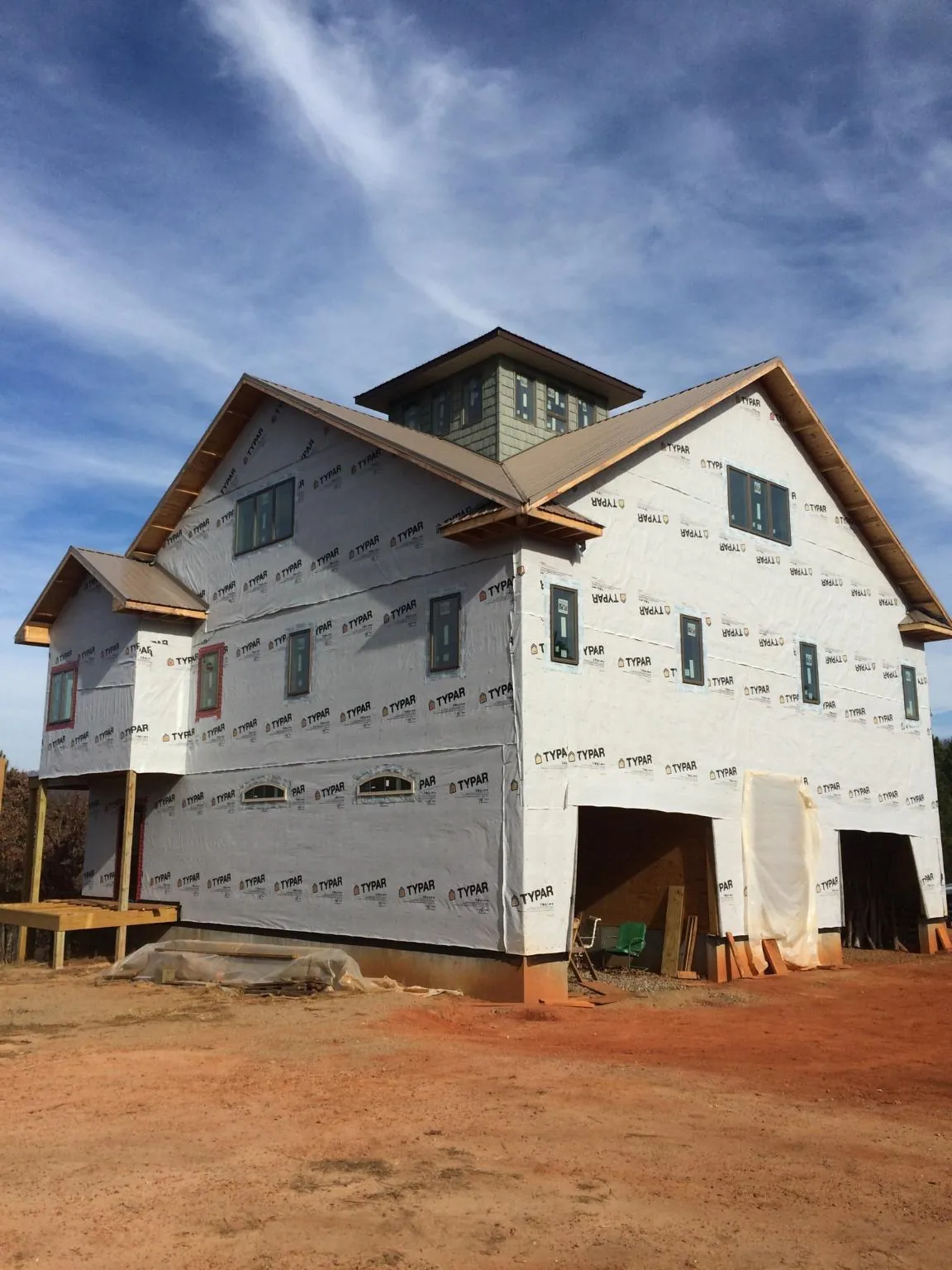 New two story house under construction with a cupola and gabled roofs in Branford
